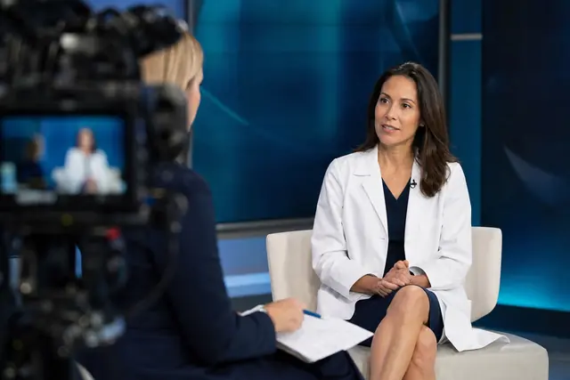 A Utah Cancer Specialists physician interviewed on a TV news set