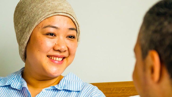 Female cancer patient talking with her doctor