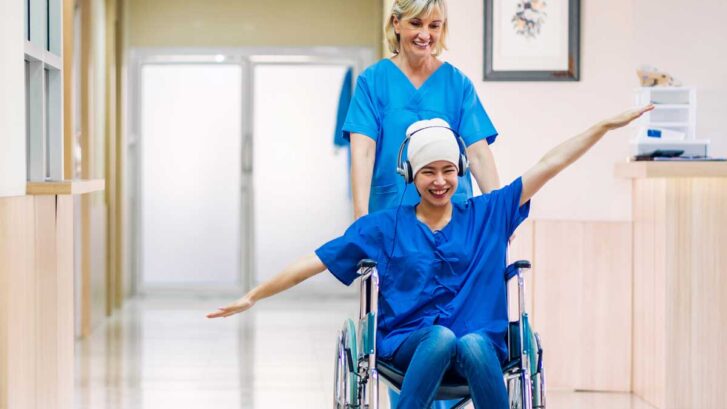 Joyful patient being guided through the hospital.